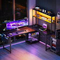 Black L‑Shaped Gaming Desk with LED, Outlets & Shelves
